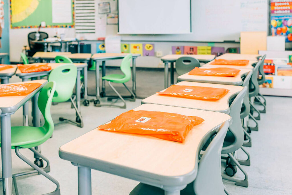 JIM packets on desks in empty classroom